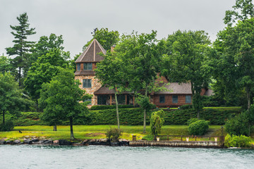 House on one of 1000 Islands. USA - Canada. Rainy day.
