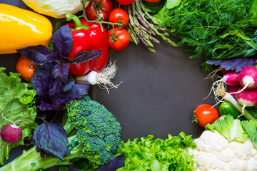 Fresh spring colorful vegetables on black chalkboard