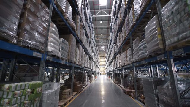 big factory warehouse. store Aisles. Camera travels inside a large store. Warehouse shipping. Large warehouse logistics terminal. Moving camera