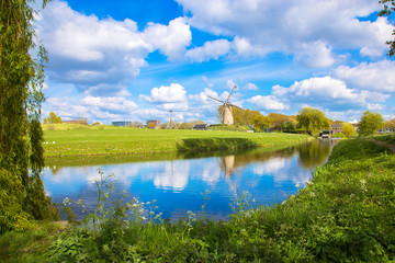 Fototapeta na wymiar Windmill and channel, Dutch landscape.