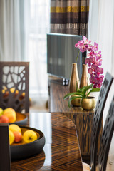 Interior decor with table, flowers and fruits. Modern flat.