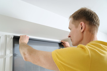 Fototapeta premium Man with window blind.