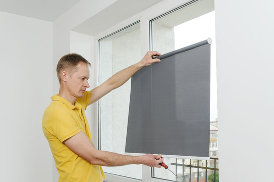 Man with window blind.