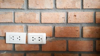 Plug on brick wall