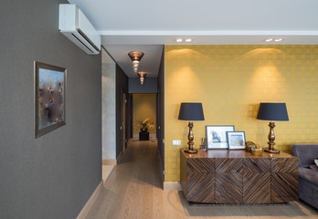  Chest of drawers. Decor with lamps and pictures in modern interior.