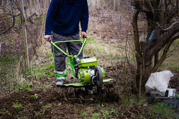 Motor-cultivator at the ploughed kitchen garden.