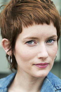 Close-up portrait of confident woman with short hair