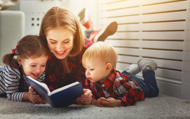 Mother reads book to children