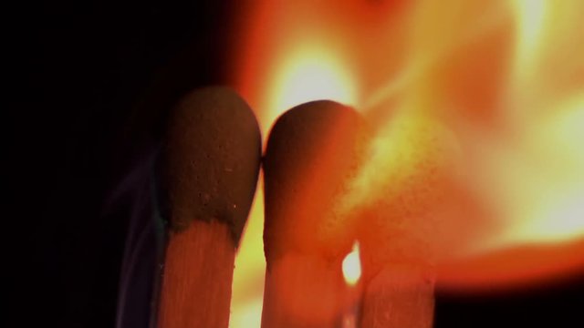 Matches inginiting burning extreme macro close up background. A beautiful flame burns a matches slowly.
Macro extreme close up shot of a wooden matches igniting after being heated up,and bursting