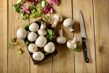 Champignon mushrooms on wooden table