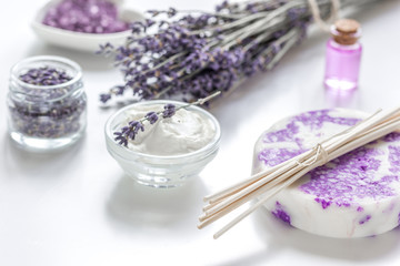 Fototapeta na wymiar lavender herbs in body care cosmetics with oil on white table background