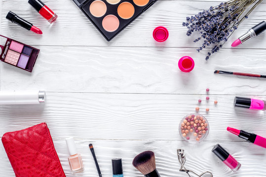 set of cosmetics for women with lavender white background top view mockup