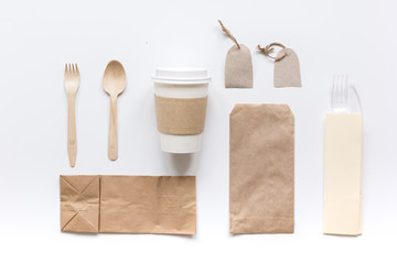 food delivery with paper bags and plastic cup on gray table background top view mockup