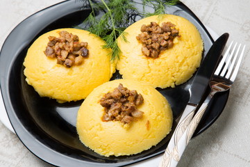 Mamaliga with cracklings on a plate.