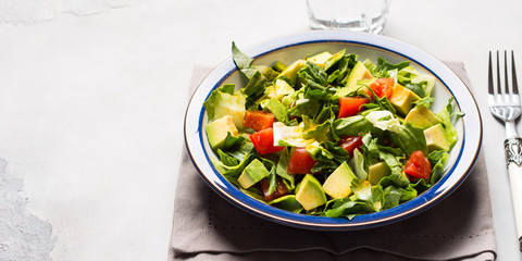 Healthy avocado spinach tomato salad. Gourmet dieting