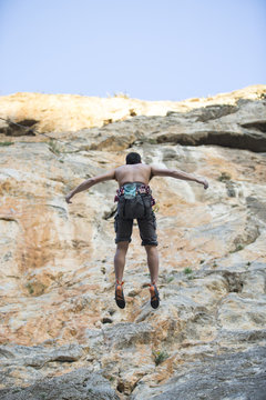 Young man climbing. Rock climber.