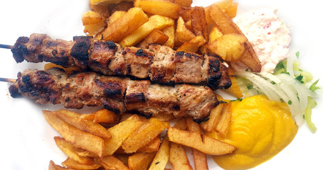 Souvlaki with onion,mustard and french fries