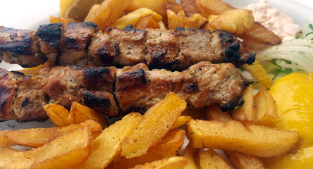 Souvlaki with onion,mustard and french fries