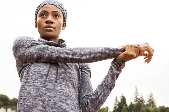 Serious Black Athlete Stretching Arms