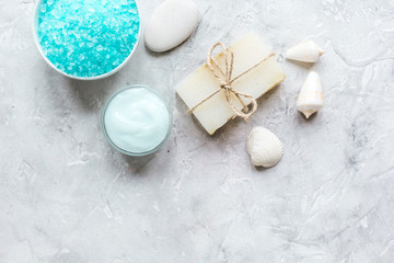Home cosmetic with cream and sea salt on stone background top view mock-up