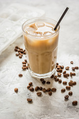 iced coffee with beans for cold summer drink on stone background