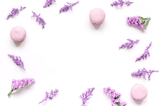 Fototapeta spring design pastel color with macaroons and flowers top view mock up