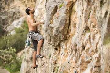 Young man climbing on a wall