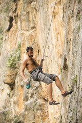 Young man climbing on a wall