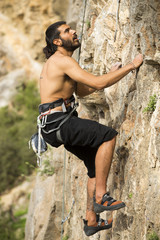 Young man climbing on a wall