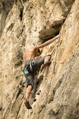 Young man climbing on a wall