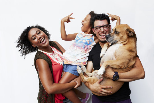 Man and woman holding daughter and dog