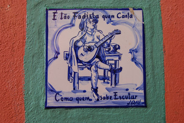 Hand painted azulejo tile showing Fado guitar player