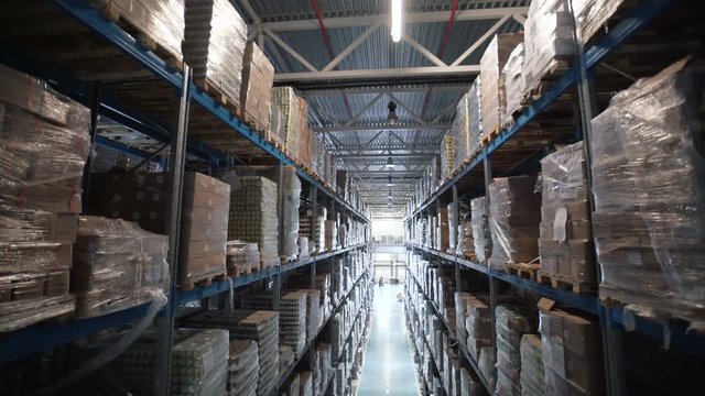 big factory warehouse. store Aisles. Camera travels inside a large store. Warehouse shipping. Logistics business and shipping facility with forklift to move boxes and goods