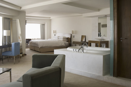Modern hotel room with open bathroom in center