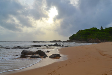 Fototapeta na wymiar Indian ocean with golden sand, Bentota, Sri Lanka. A wonderful nature landscape of a beach scene.