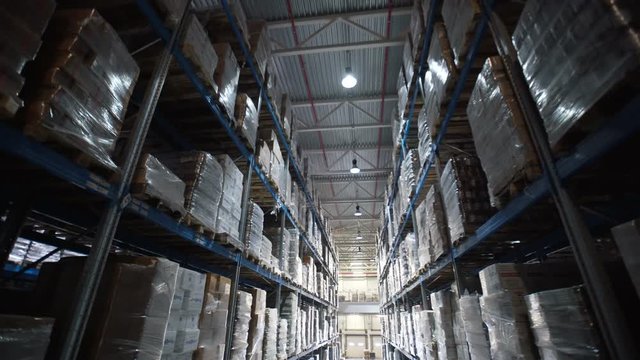 big factory warehouse. store Aisles. Camera travels inside a large store. Warehouse shipping. Logistics business and shipping facility with forklift to move boxes and goods