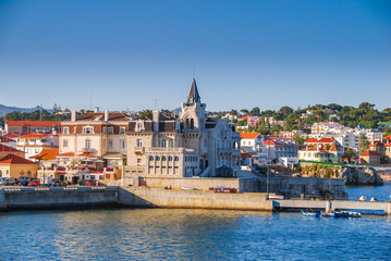 View os Cascais from the water with mediterranean architecture buildings at sunset - obrazy, fototapety, plakaty
