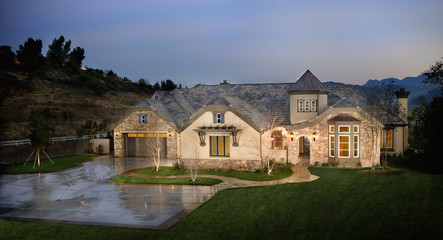 Exterior view of Tudor style illuminated house at dusk