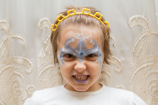 Portrait of little girl with face painting