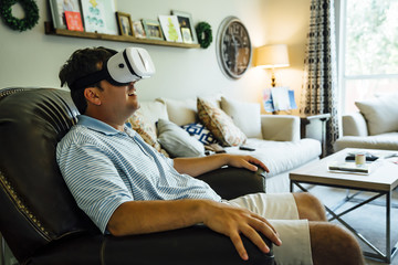Caucasian man wearing virtual reality goggles