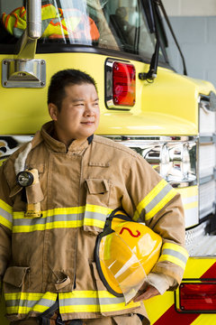 Firefighter standing near fire engine
