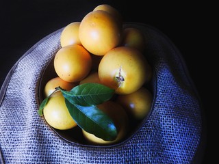  Close Abiu yellow exotic fruit inside the natural fiber sub exposure hat seen from above with...