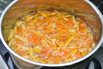 Candied fruits are cooked in a saucepan