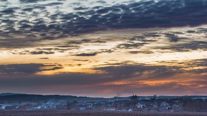 Sunset colorful sky over polish village in spring