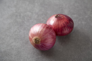 Red onions on Gray granite slab