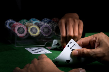 The battle in card games of blackjack at a casino with chips on a green blackjack table