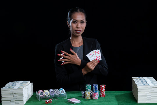 Female clamp red dices between her fingers and holding Hearts Suit Straight Flush