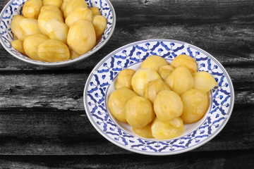 Mini green mango compote served in Thai pattern plate.