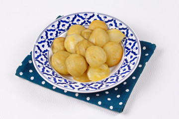 Mini green mango compote served in Thai pattern plate.