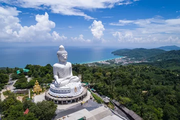 Fototapeten White buddha statue on top of the mountain with blue sky in Phuket © Ratnapha